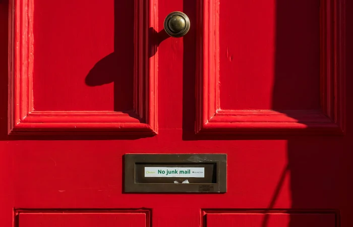 A door with a blocked mailbox witht he text no spam