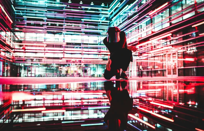 a man kneeling in a room full of lights