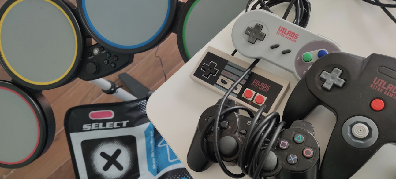 Picture of controllers for NES, SNES, Nintendo64, PlayStation 2, PlayStation 3, drumset, and DDR mat